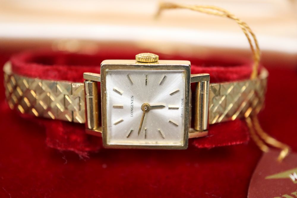A ladys 9ct gold Longines manual wind square dial wrist watch, on 9ct bracelet, with Longines box,